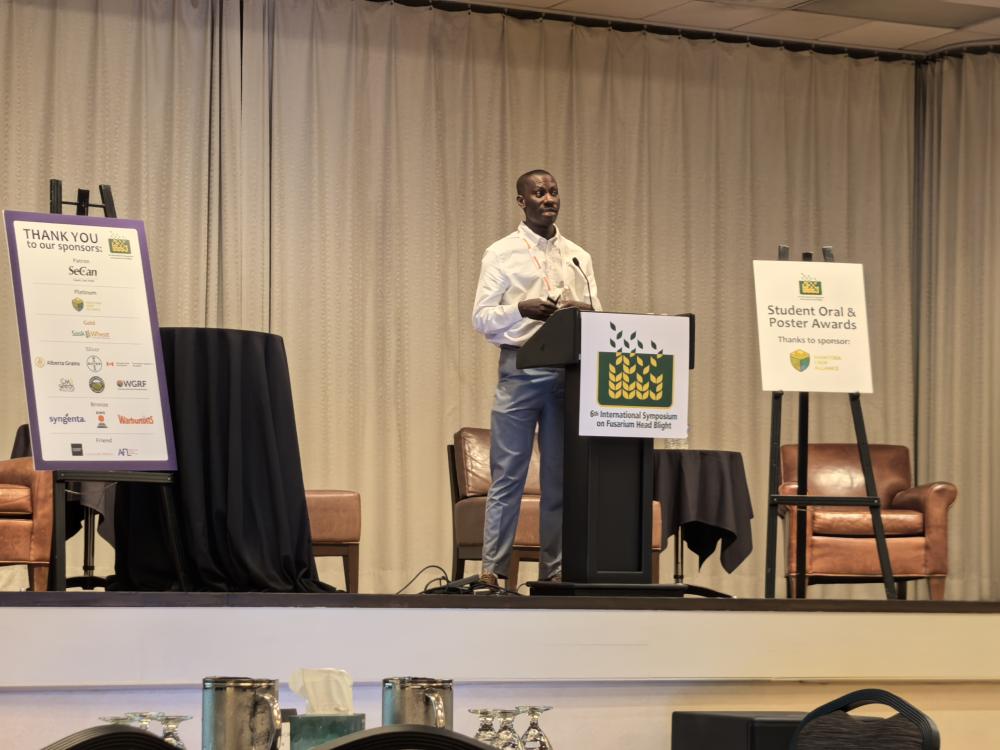 A man behind a podium presenting to a conference