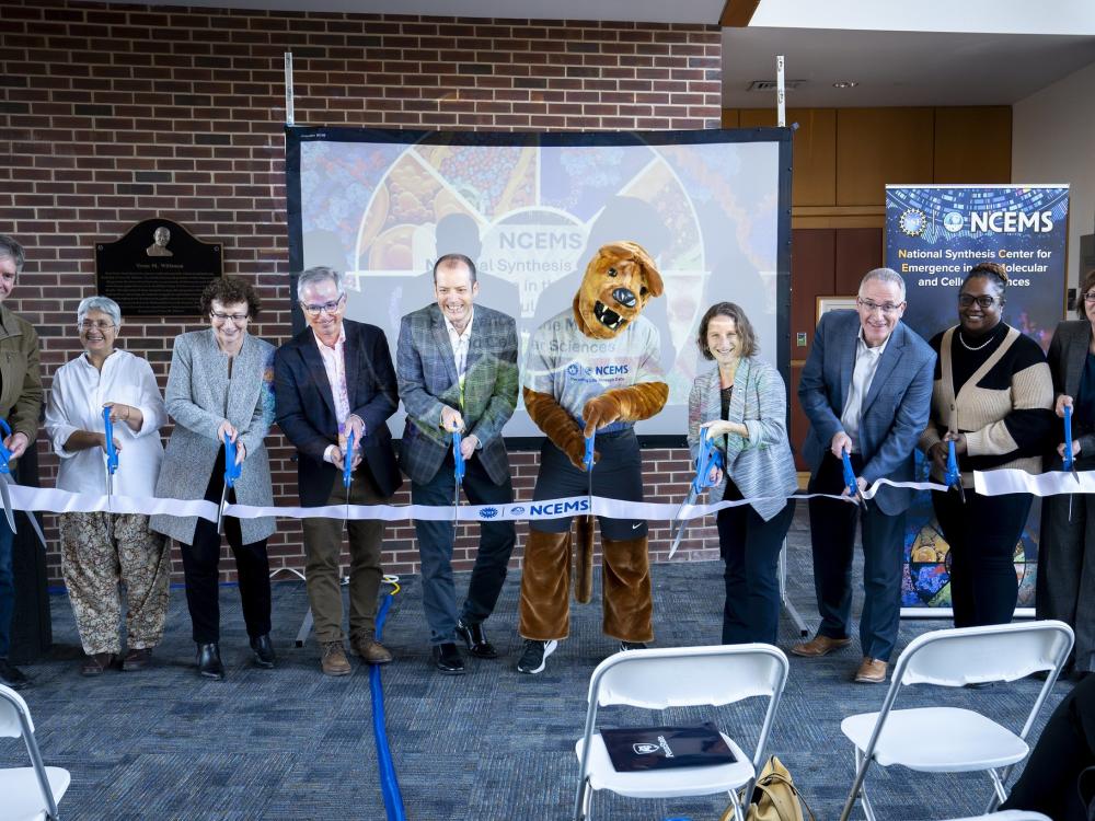 Penn State and U.S. National Science Foundation representatives cut a ribbon celebrating the official launch of the U.S. National Science Foundation National Synthesis Center for Emergence in the Molecular and Cellular Sciences (NCEMS) with the Penn State Nittany Lion mascot. 