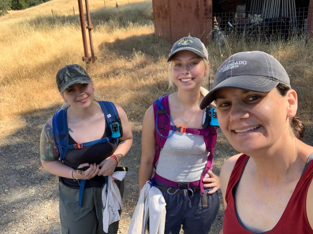 three women posing for selfie wearing backpacks