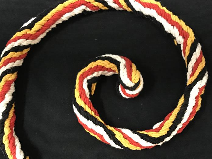 A spiral section of a rope with vibrant colors that was braided using ancient Incan techniques.