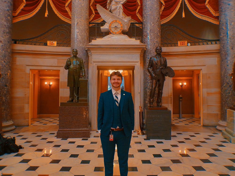 Hunter Steach stands in the National Statuary Hall area of the U.S. Capitol Building.