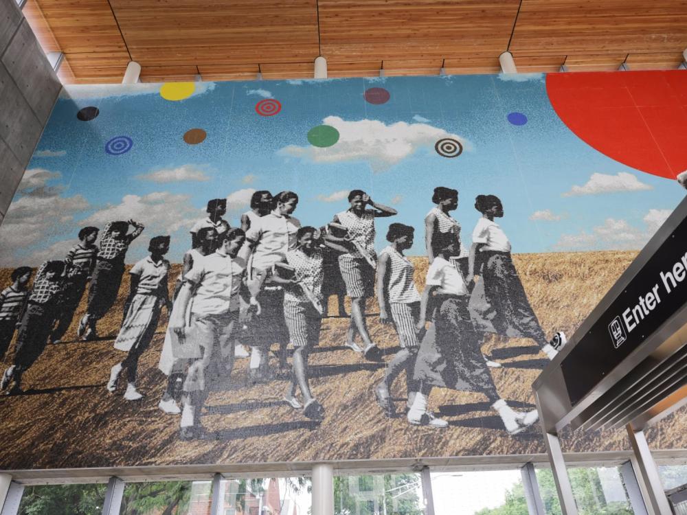 Mural showing people of color walking across a prairie