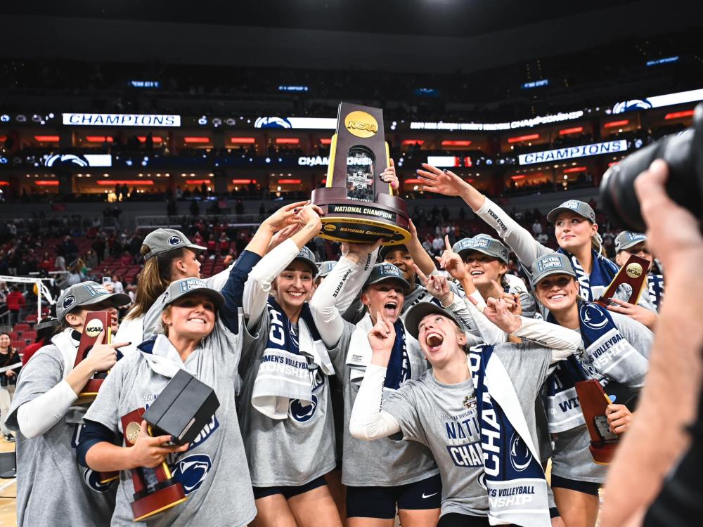 A team holds a championship trophy