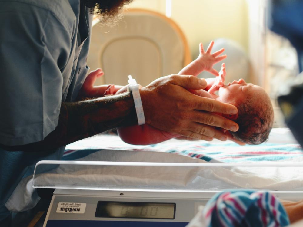 Person holds a newborn