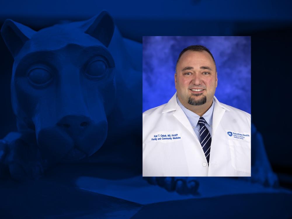 A photo of a man smiling is overlaid on a blue background with a statue of a lion