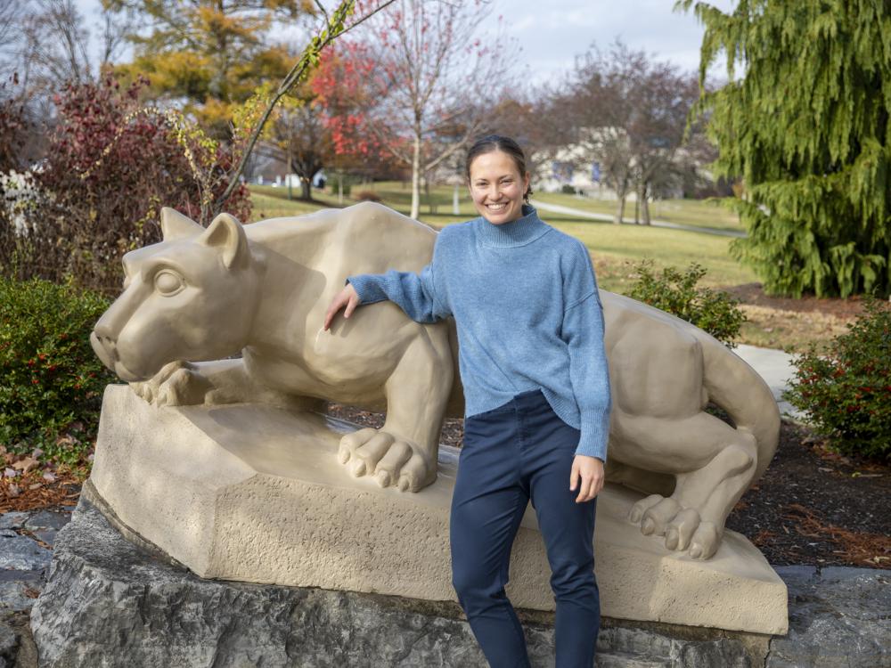 Diana Stoltzfus standing by the lion shrine