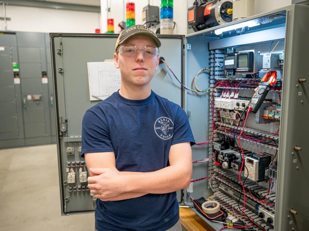 Gage L. Romanoskie standing among equipment