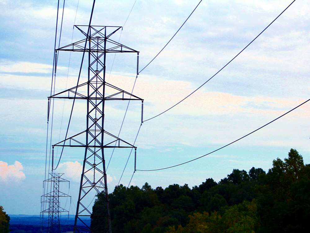 Power lines against blue sky