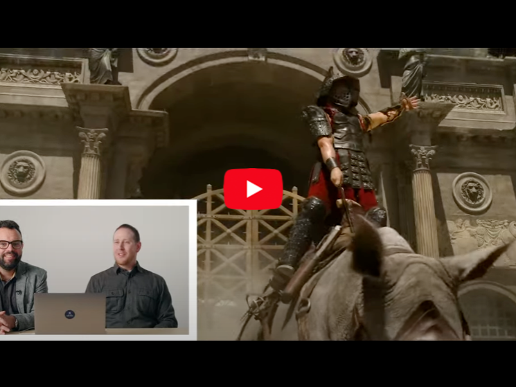An inset of two faculty members with a larger screenshot of a video of a gladiator riding a rhinoceros from the movie "Gladiator II"