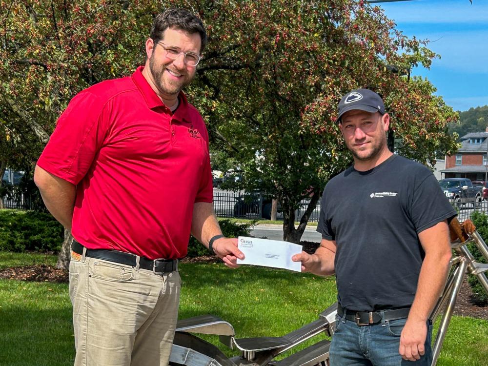 Two men stand next to a piece of metal equipment(Credit: Shanin L. Dougherty, Penn College) 