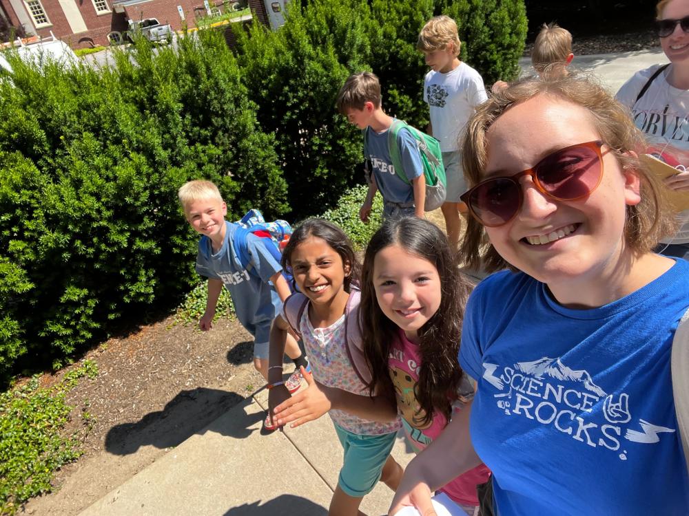 Science-U instructor taking a selfie while walking with Science-U campers