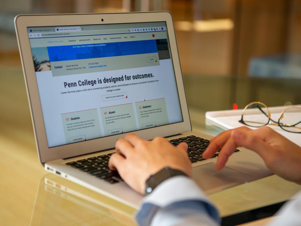 A person works on a laptop computer