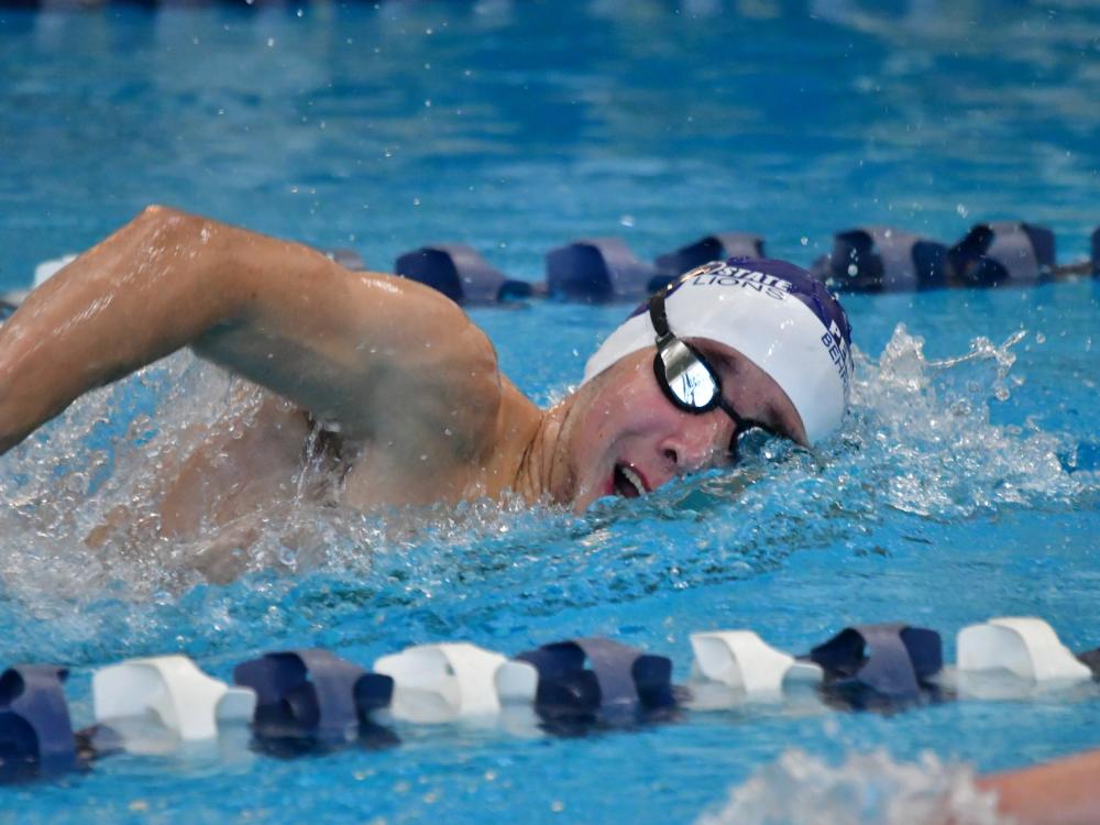 A male swimmer competes in a race for Penn State Behrend.