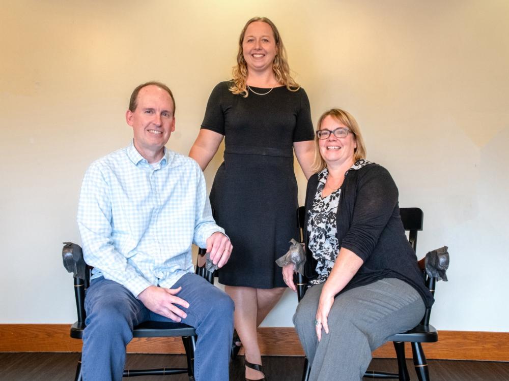 Lindsey Simon-Jones standing in between Kevin Maxwell and Nicole Hill.
