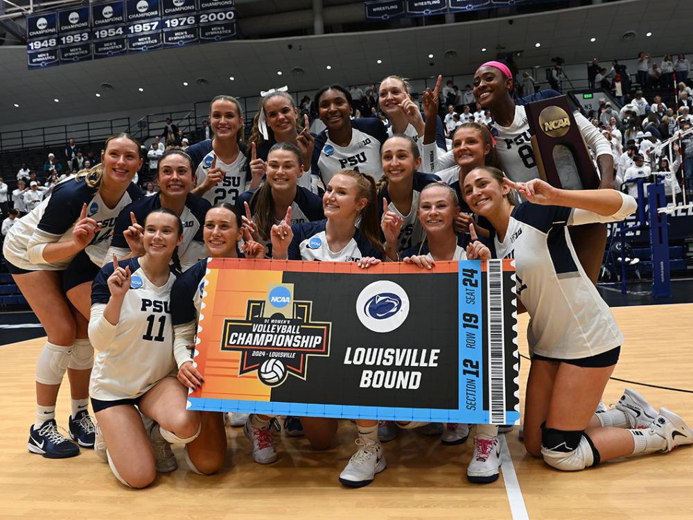Women's volleyball team poses after victory
