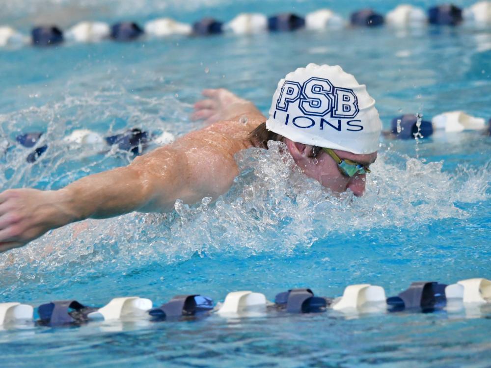 A Penn State Behrend swimmer competes in a butterfly event.