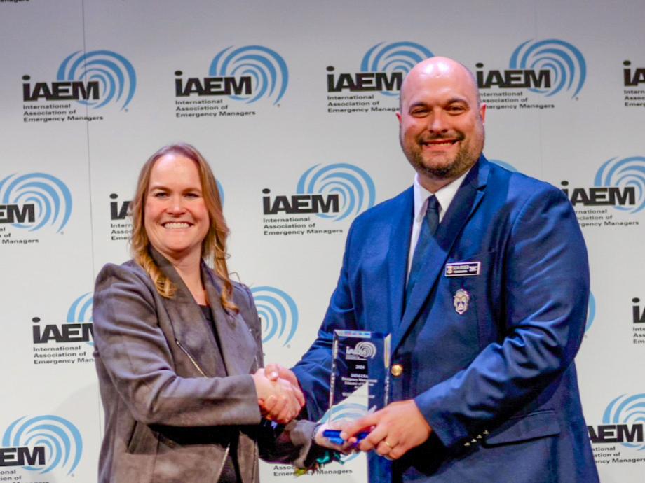 William A. Schlosser receives an award from Carrie Speranza