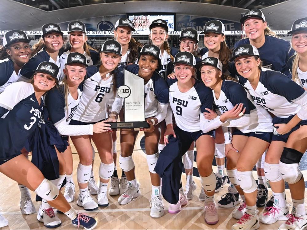 Women's volleyball team poses with Big Ten trophy