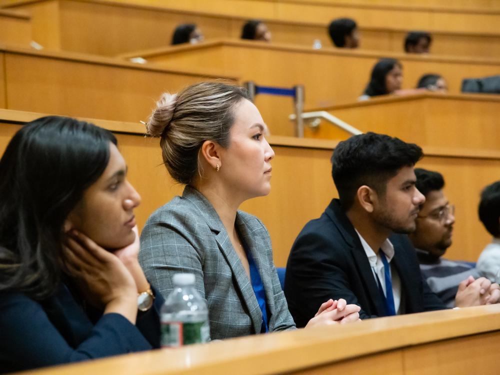 Three students watching a lecture