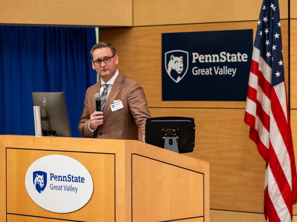 Professor and chancellor Colin J. Neill speaks at a podium at Penn State Great Valley