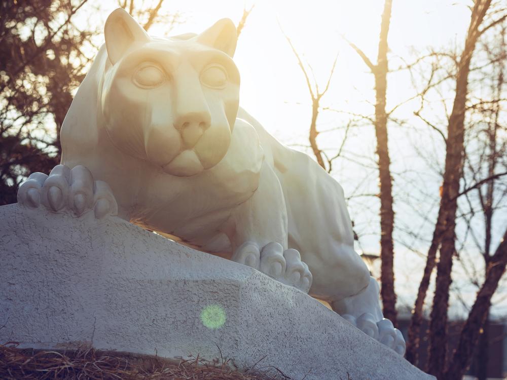 A photo of the lion shrine in late fall with sunlight behind it