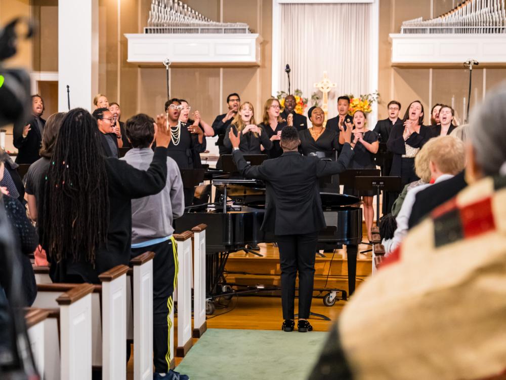 A diverse chorus performs in a church.