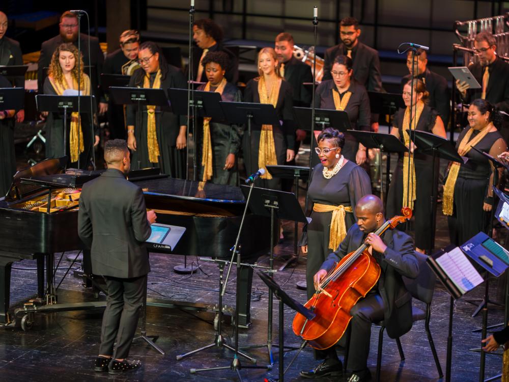 A diverse choir performs on a stage.