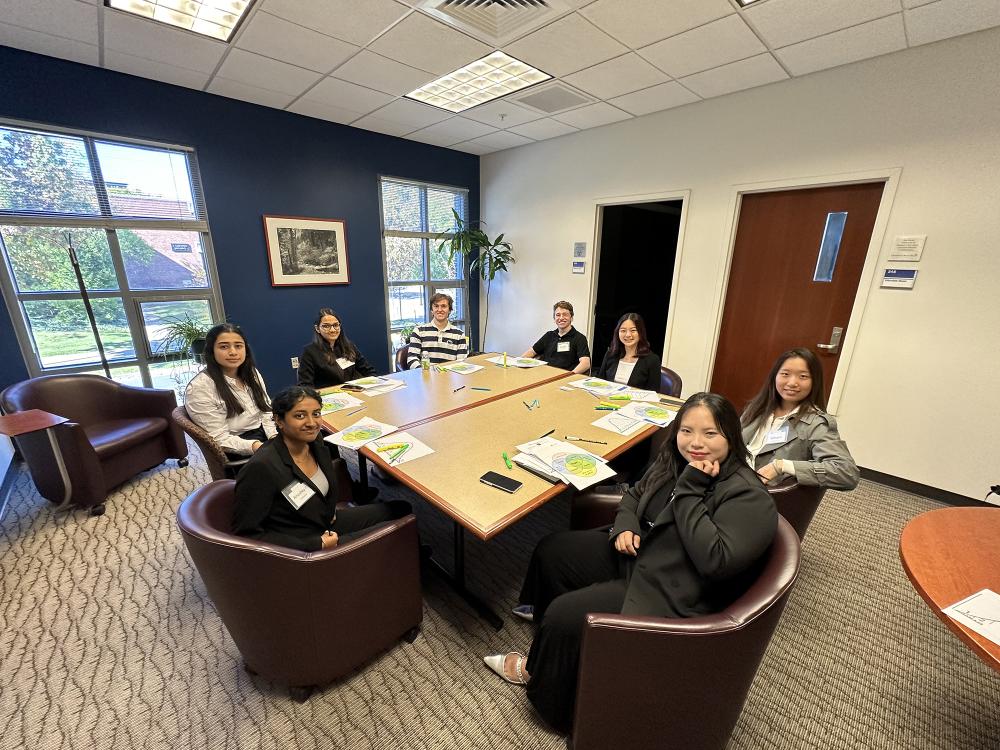 students sitting around a conference table