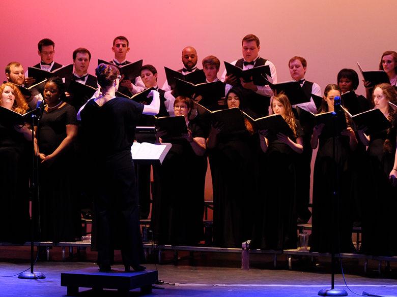 A choir wearing black performs a choral work