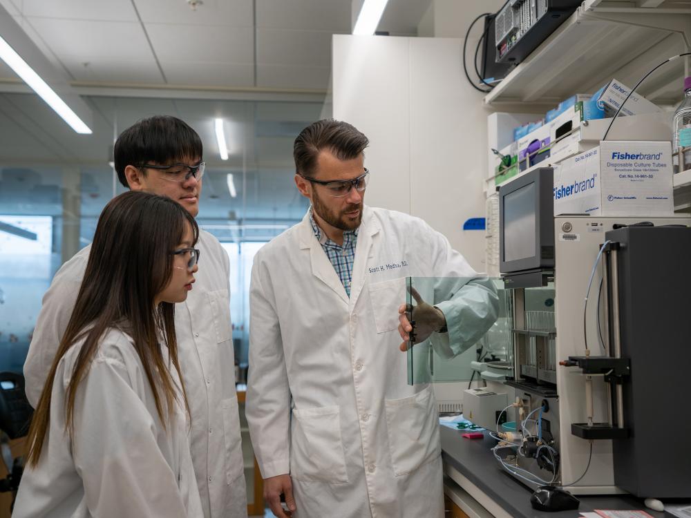 Researchers in lab coats standing in a lab