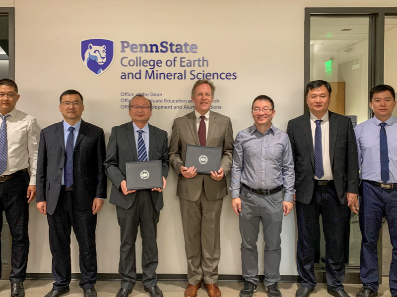 A delegation from The Shandong University of Science and Technology and Penn State counterparts holding signed memorandum of understanding.