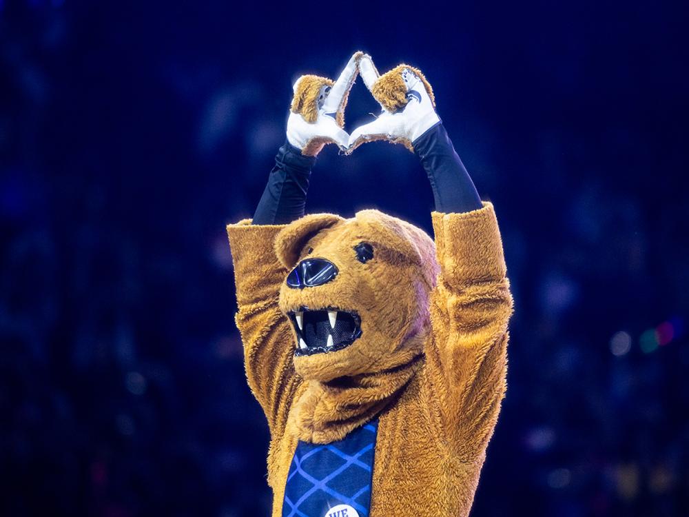 The Penn State Nittany Lion mascot holds his hands above his head forming a diamond during the annual THON fundraiser.