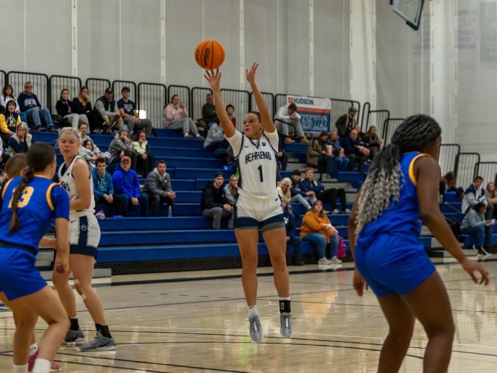 A member of the Penn State Behrend women's basketball team shoots a jump shot.