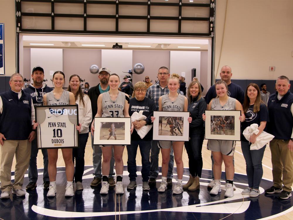 A group photo from the 2025 Penn State DuBois women’s basketball team senior day festivities. Members of the team that were honored are joined by family members and members of the coaching staff.