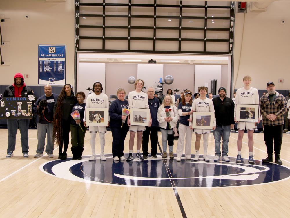 A group photo from the 2025 Penn State DuBois men’s basketball team senior day festivities. Members of the team that were honored are joined by family members on the PAW Center court.