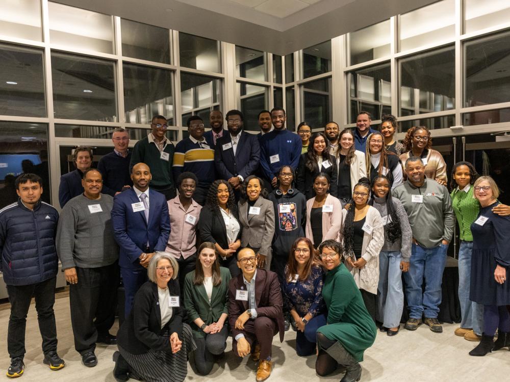 A large group of people gather for a photo at an event