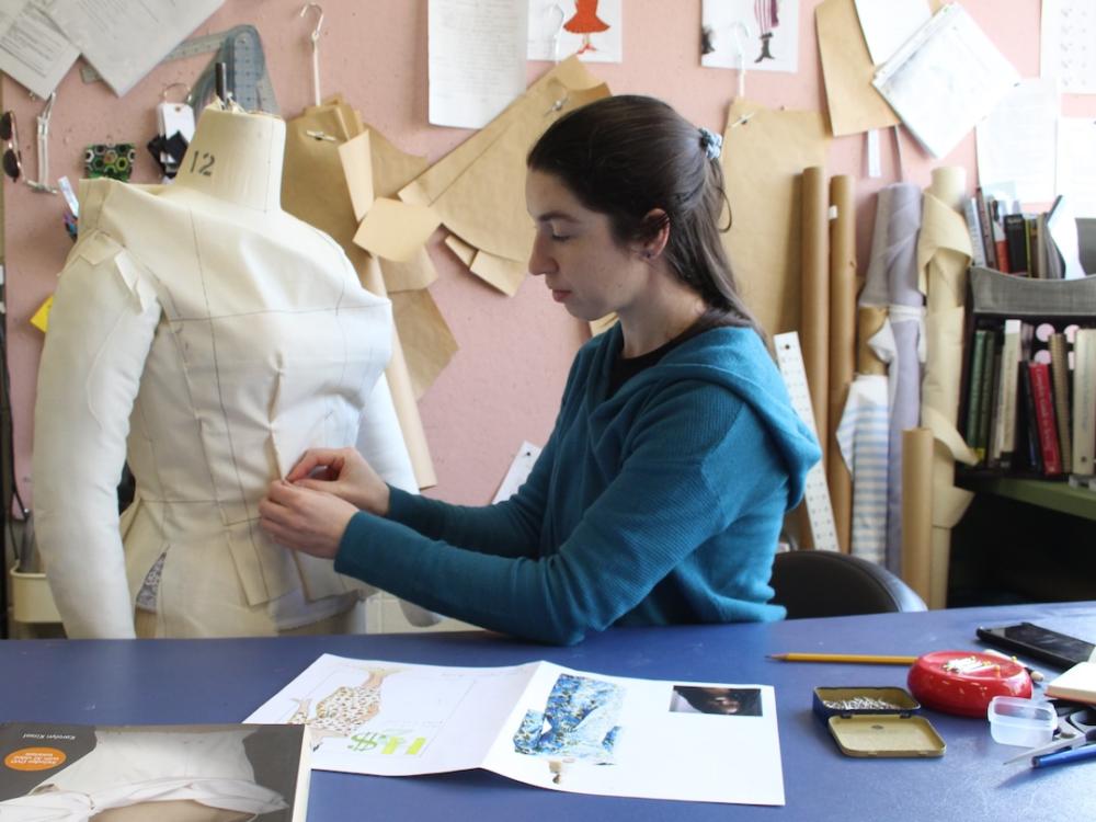 A woman working on a costume