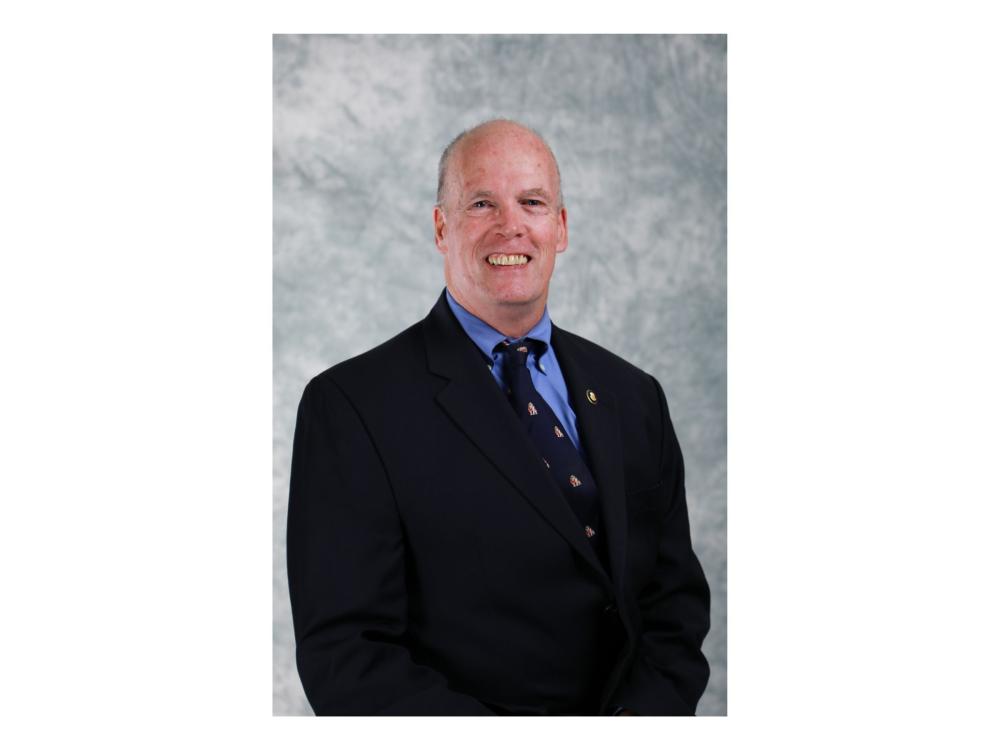 seated person wearing navy business suit