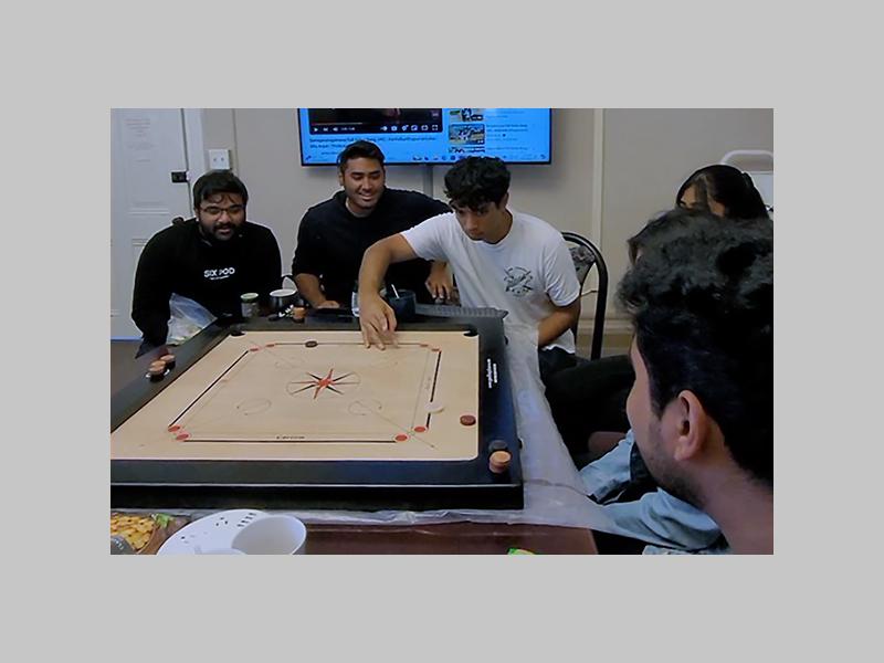 Penn State students playing a game of carrom