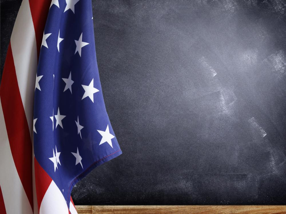 American flag in front of blackboard