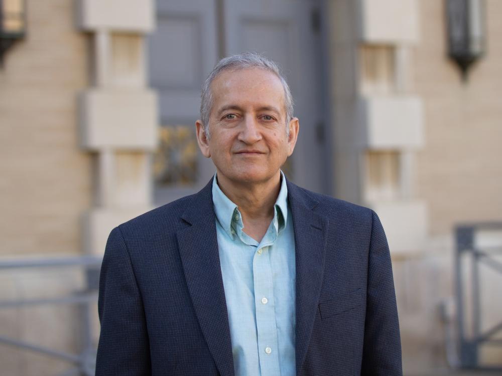 Portrait photograph of researcher standing outside building