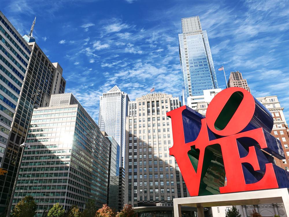 View of the Love statue in Love Park in Philadelphia, with the city skyline in the background