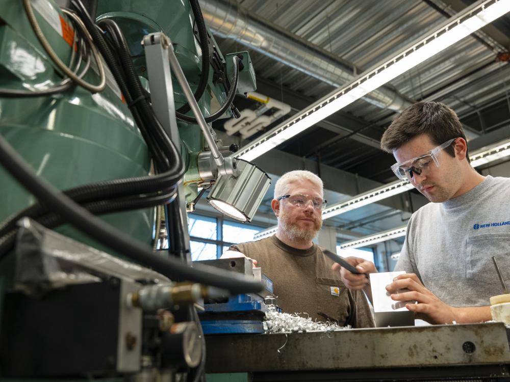 Student and instructor working at MILL machine