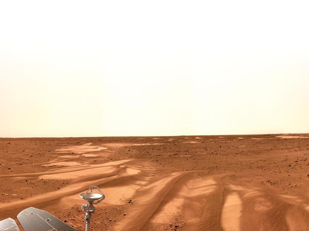 A panoramic photo showing dune-like shapes on Mars