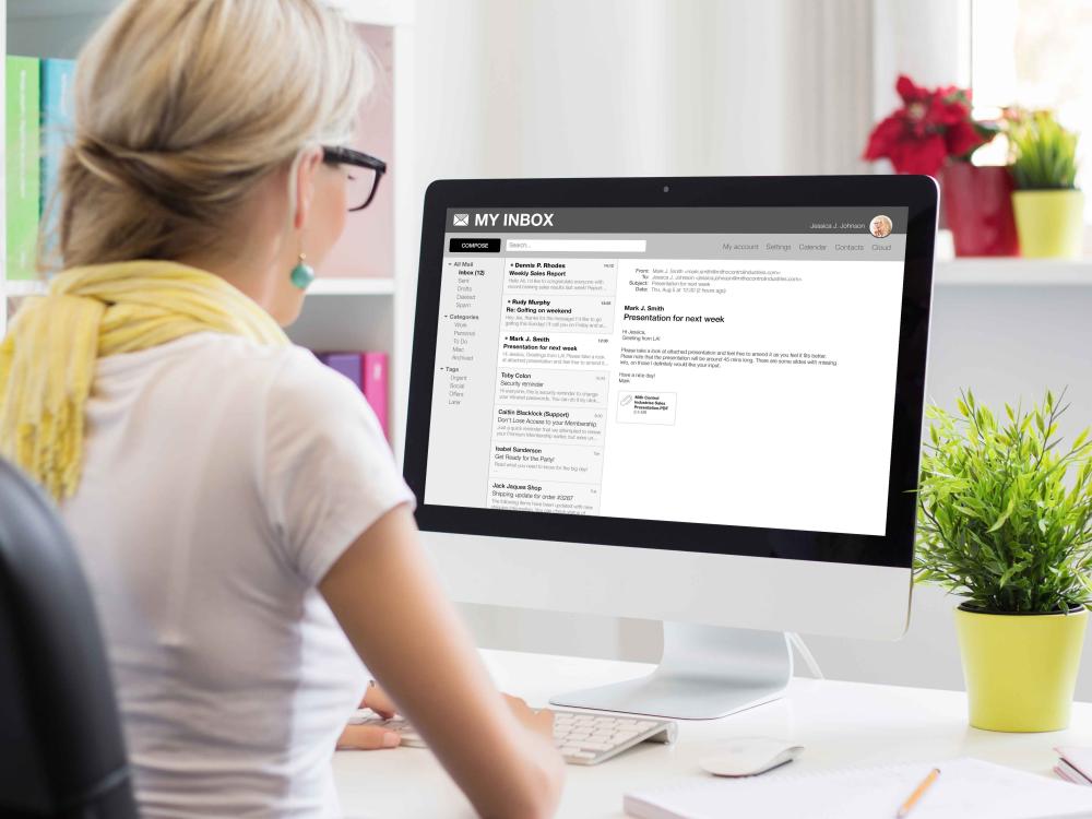 Person reading email on desktop computer