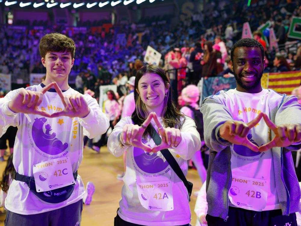 people standing with hands in diamond shape