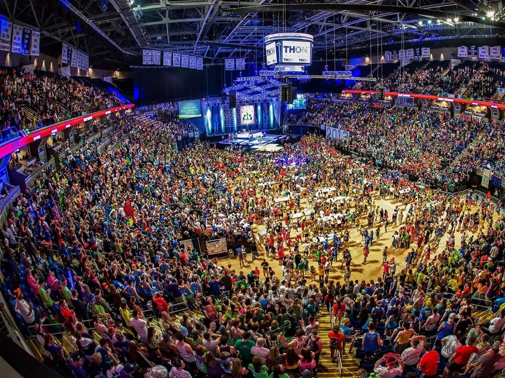 A crowd of people in colorful T-shirts at THON