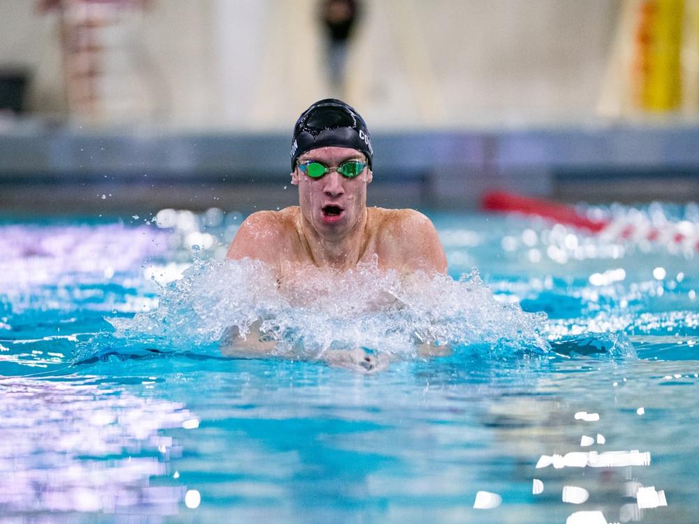 Penn State Behrend swimmer Tim Compton competes in a breaststroke race.