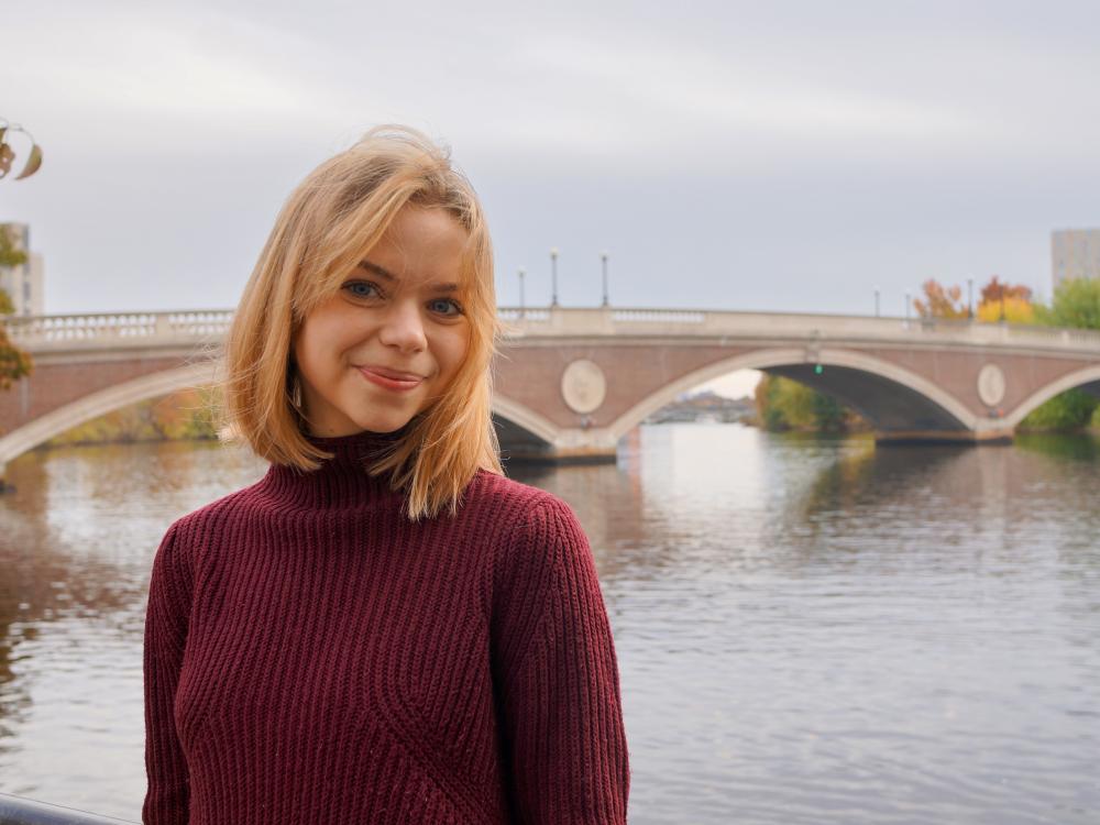 Nora Van Horn stands in front of the Harvard Bridge.