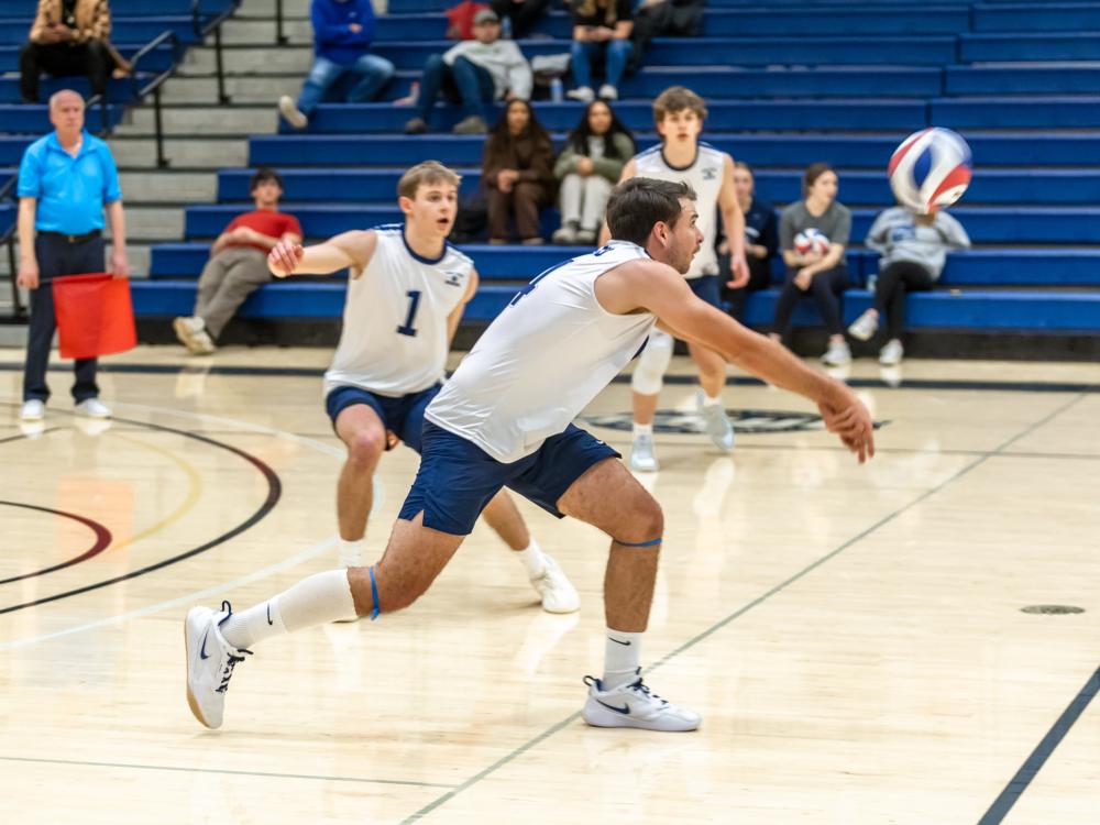 A Penn State Behrend volleyball player hits the ball with a dig.